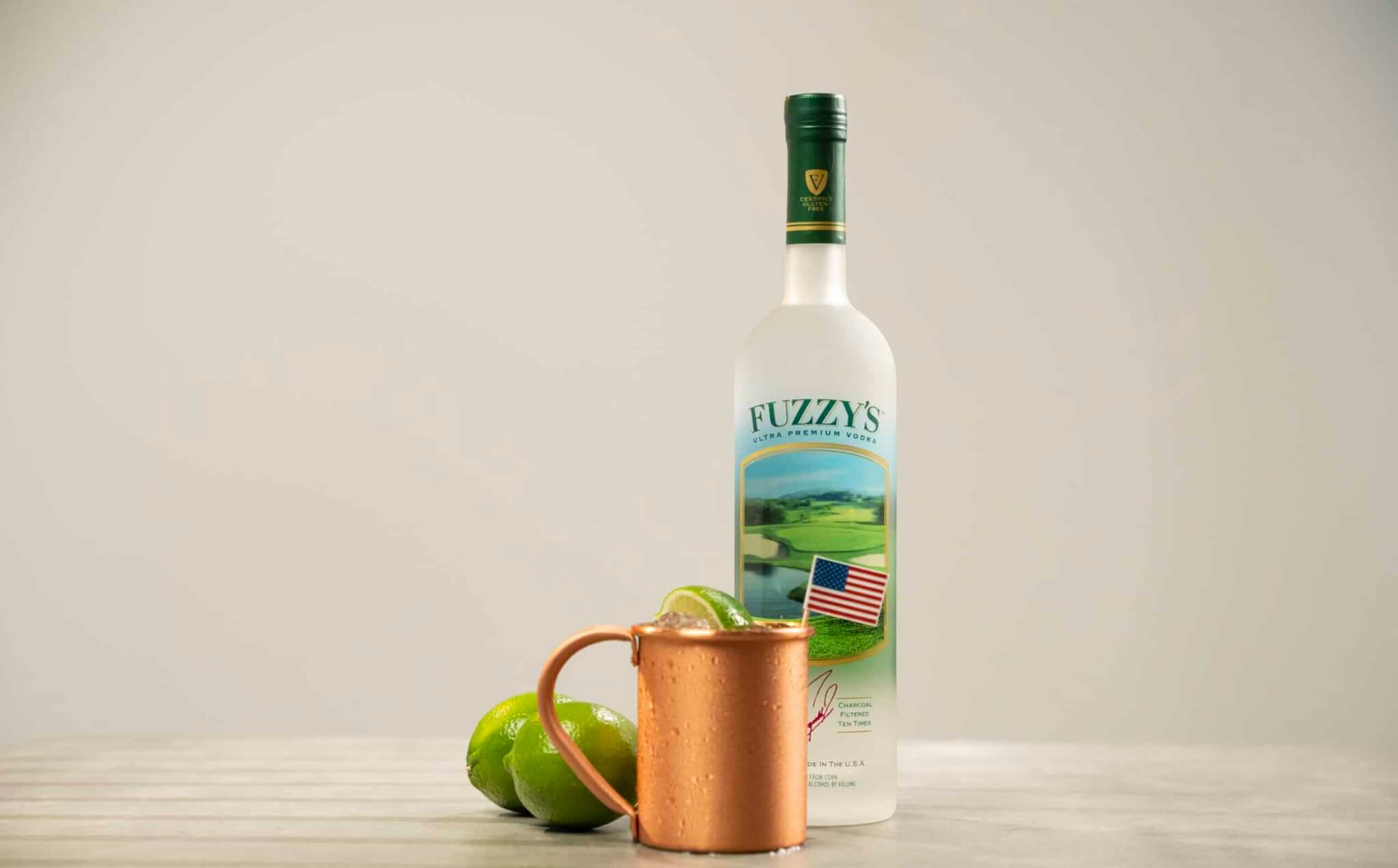 Fuzzy's Vodka bottle with a copper cup with American Stallion cocktail