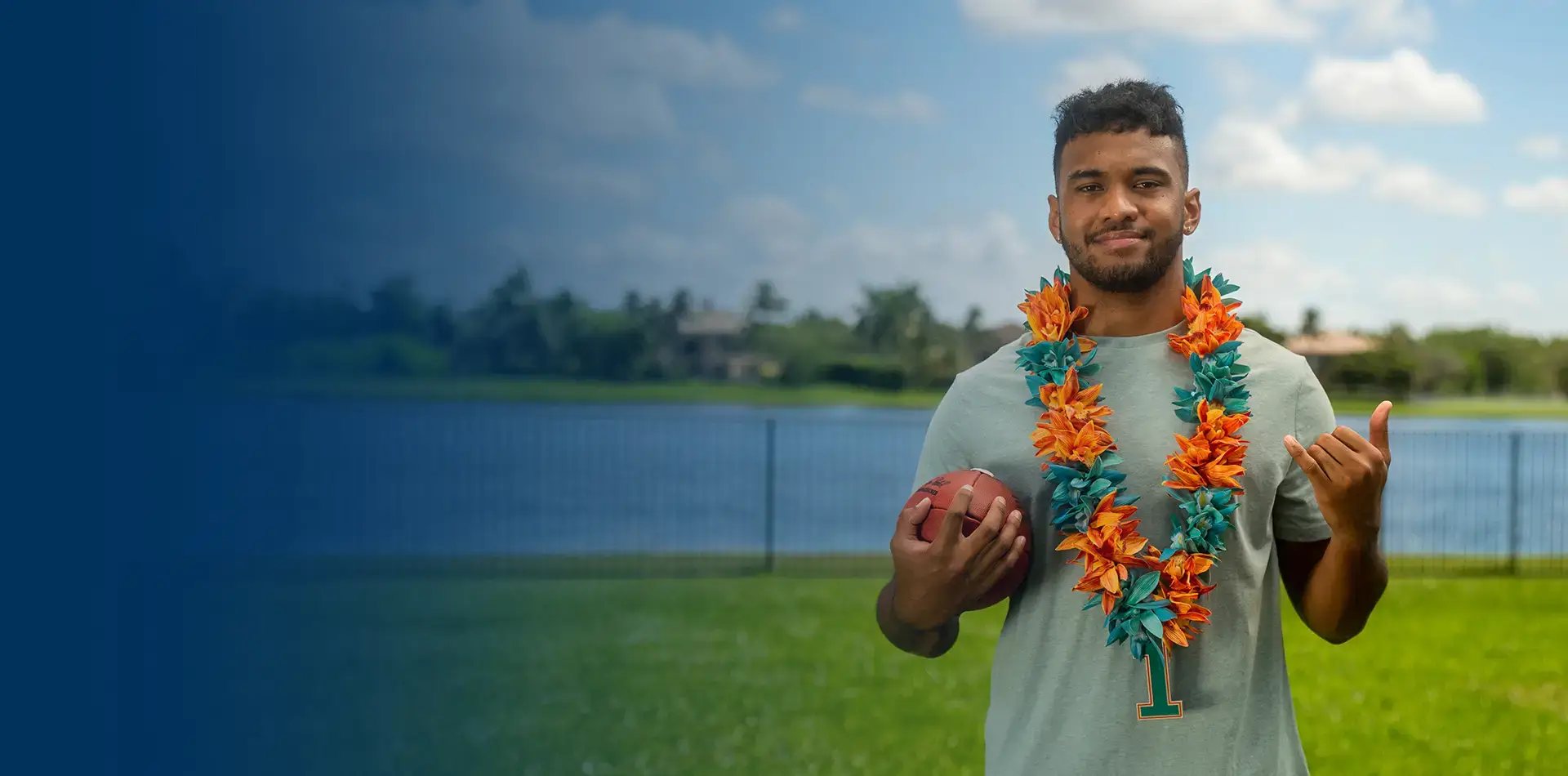 Tua Leis with a football for the campaign with South Florals